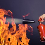 man with extinguisher fighting a fire